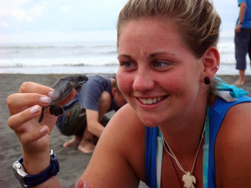Female holding a baby turtle in Costa Rica
