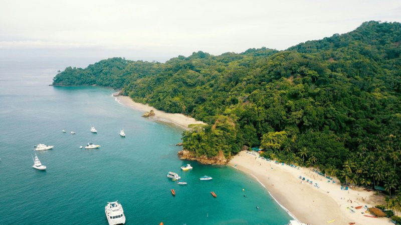 Costa Rica beach with luxury boats in the sea and jungle